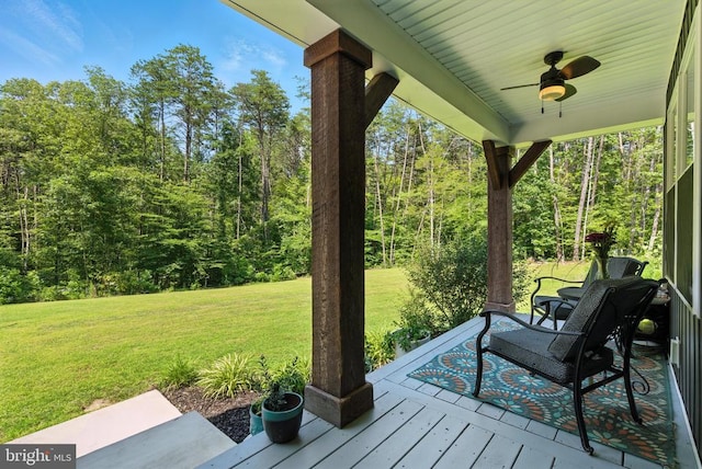 275 Freestyle Ln, Mineral, VA 23117 - wooden deck with a ceiling fan, a yard, and a wooded view