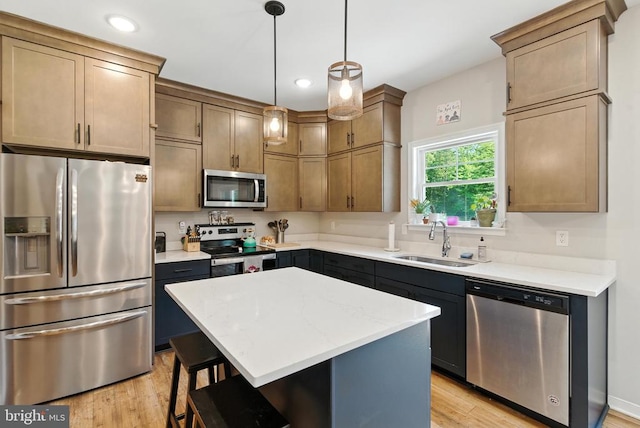 275 Freestyle Ln, Mineral, VA 23117 - kitchen with appliances with stainless steel finishes, a kitchen breakfast bar, a center island, light wood finished floors, and recessed lighting