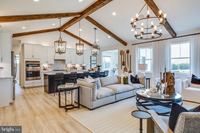 living area featuring a chandelier, light wood-style flooring, and recessed lighting