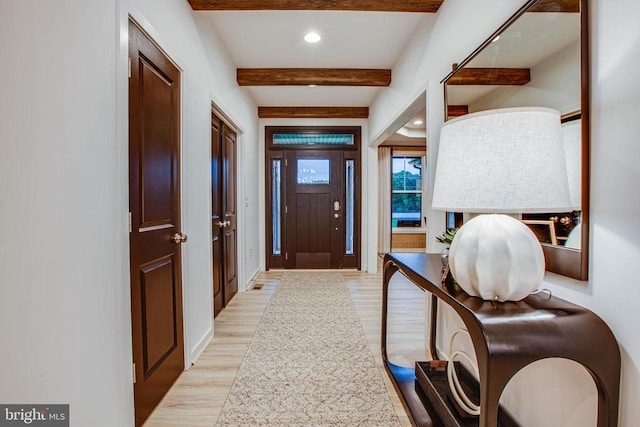 foyer entrance featuring light wood finished floors, beamed ceiling, recessed lighting, and baseboards
