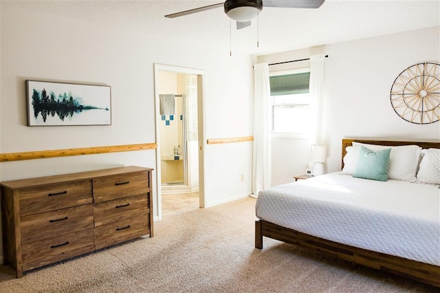 bedroom featuring connected bathroom, light carpet, and a ceiling fan