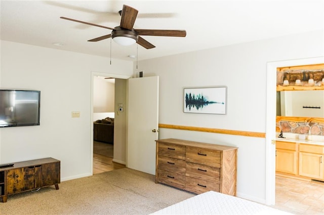 bedroom with ensuite bath, ceiling fan, and carpet floors