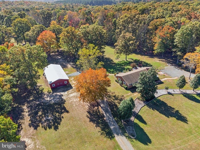 view of subject property featuring a heavily wooded area