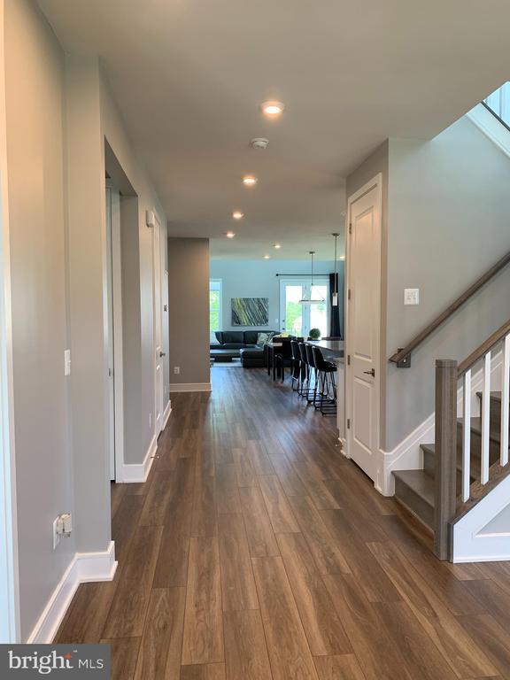  - corridor featuring dark wood-style floors, stairway, and recessed lighting