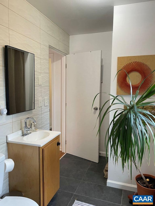 815 Ridge St, Charlottesville, VA 22902 - bathroom featuring vanity, tile patterned flooring, tile walls, and tasteful backsplash