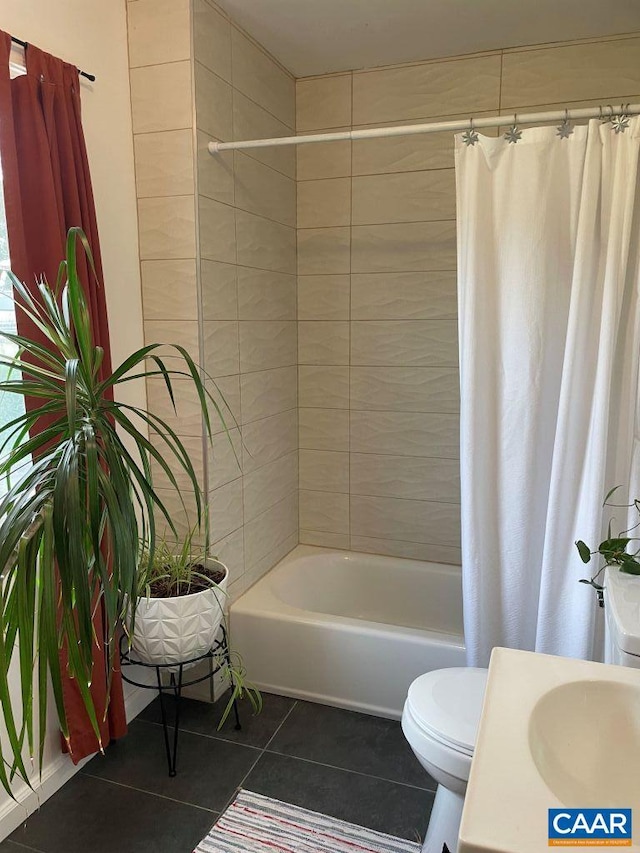815 Ridge St, Charlottesville, VA 22902 - bathroom featuring tile patterned floors, toilet, shower / tub combo with curtain, and a sink