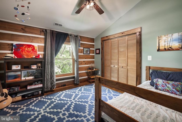bedroom featuring lofted ceiling, wood finished floors, and a ceiling fan