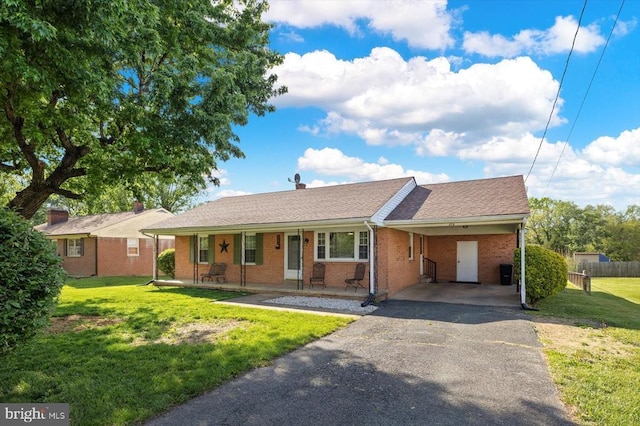 316 Grove Ave, Gordonsville, VA 22942 - ranch-style house featuring a porch, aphalt driveway, brick siding, an attached carport, and a front lawn
