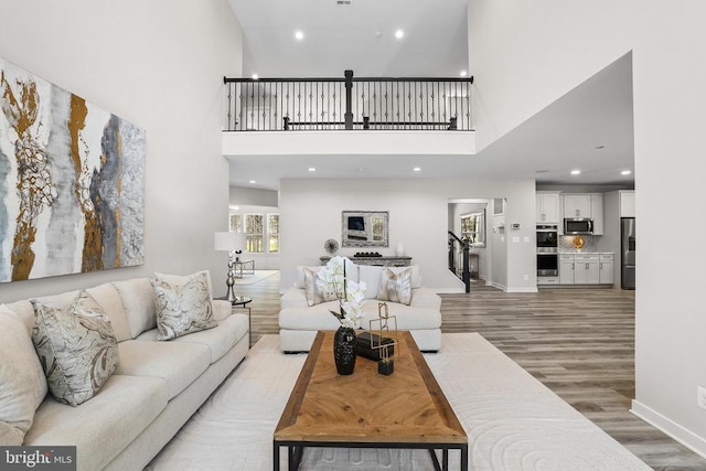 7806 Shawmont Rd, Fredericksburg, VA 22407 - living area with a high ceiling, light wood-style flooring, recessed lighting, and baseboards