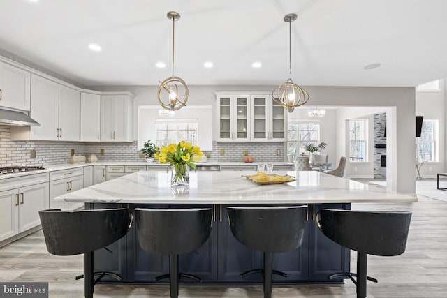 7806 Shawmont Rd, Fredericksburg, VA 22407 - kitchen with white cabinets, decorative backsplash, plenty of natural light, and recessed lighting