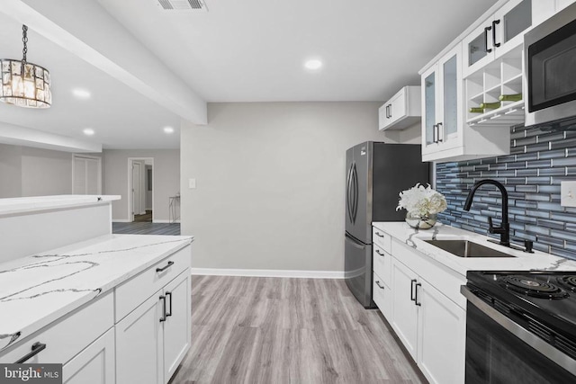 7806 Shawmont Rd, Fredericksburg, VA 22407 - kitchen featuring appliances with stainless steel finishes, a sink, light stone counters, backsplash, and recessed lighting