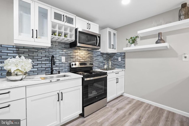 7806 Shawmont Rd, Fredericksburg, VA 22407 - kitchen featuring stainless steel appliances, a sink, open shelves, and white cabinets