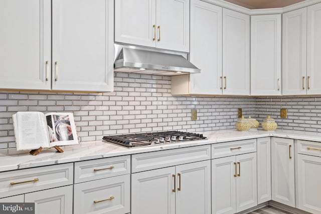 7806 Shawmont Rd, Fredericksburg, VA 22407 - kitchen with ventilation hood, stainless steel gas stovetop, white cabinetry, backsplash, and light stone counters