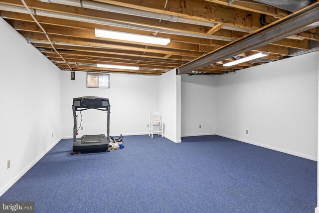 8413 Pathfinders Ct, Spotsylvania, VA 22553 - exercise room featuring dark colored carpet and baseboards