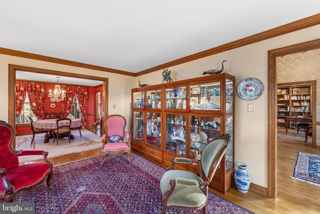 8413 Pathfinders Ct, Spotsylvania, VA 22553 - living area featuring baseboards, ornamental molding, an inviting chandelier, and wood finished floors