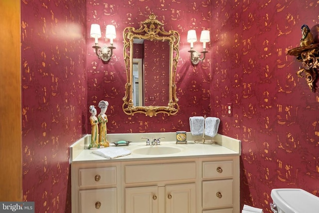8413 Pathfinders Ct, Spotsylvania, VA 22553 - bathroom with toilet, vanity, and wallpapered walls