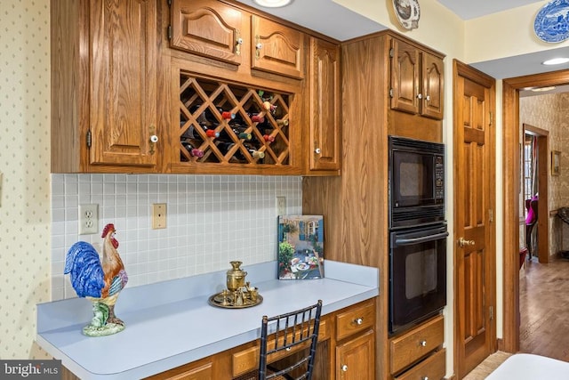 8413 Pathfinders Ct, Spotsylvania, VA 22553 - kitchen with wallpapered walls, light countertops, brown cabinets, and black appliances