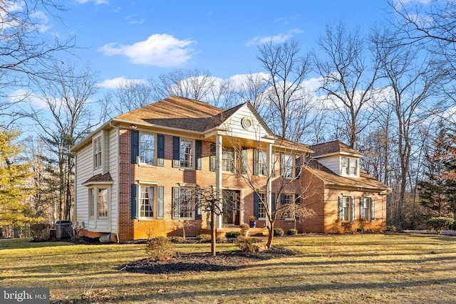 8413 Pathfinders Ct, Spotsylvania, VA 22553 - view of front facade featuring central AC unit, brick siding, and a front lawn
