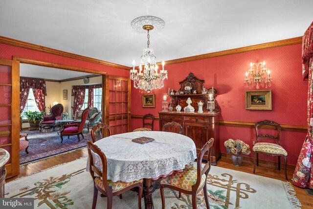 8413 Pathfinders Ct, Spotsylvania, VA 22553 - dining space featuring a notable chandelier, crown molding, and wood finished floors