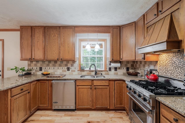 4201 Brown Mountain Ln, Elkton, VA 22827 - kitchen with appliances with stainless steel finishes, premium range hood, brown cabinets, decorative backsplash, and a textured ceiling