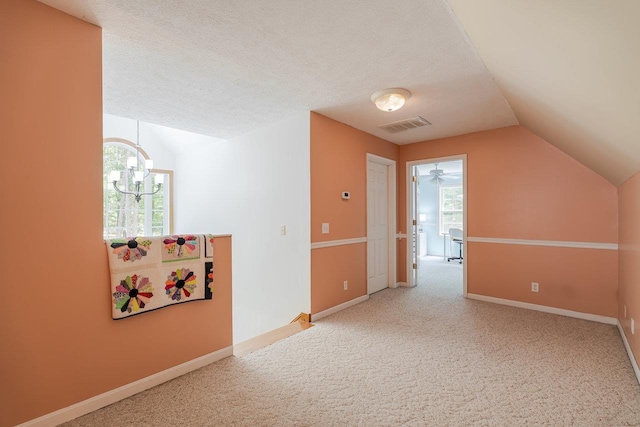 4201 Brown Mountain Ln, Elkton, VA 22827 - bonus room featuring lofted ceiling, carpet floors, a chandelier, and a textured ceiling