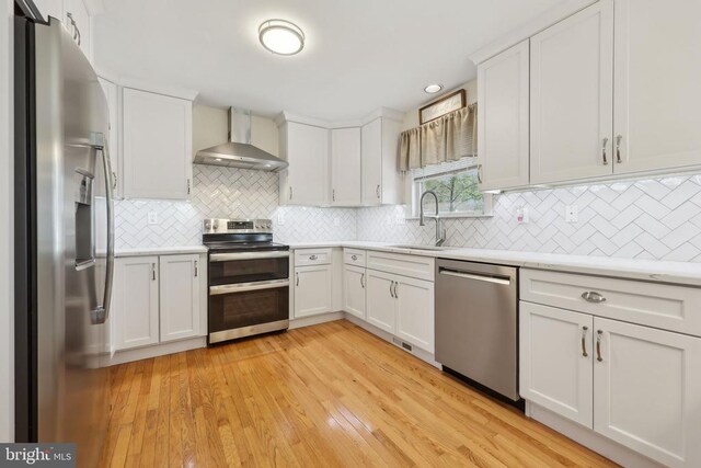 12011 Big Ben Blvd, Fredericksburg, VA 22407 - kitchen featuring wall chimney exhaust hood, stainless steel appliances, a sink, light countertops, and decorative backsplash