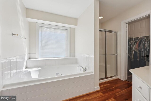 12011 Big Ben Blvd, Fredericksburg, VA 22407 - full bathroom featuring a stall shower, wood finished floors, a bath, and a spacious closet