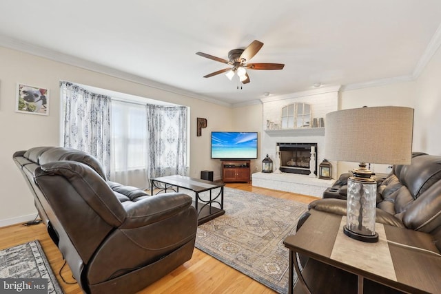 12011 Big Ben Blvd, Fredericksburg, VA 22407 - living area with ceiling fan, crown molding, light wood-style floors, a brick fireplace, and baseboards