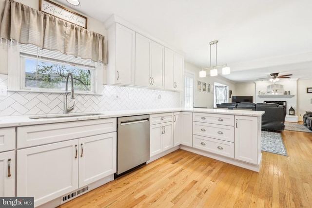 12011 Big Ben Blvd, Fredericksburg, VA 22407 - kitchen featuring stainless steel dishwasher, a sink, white cabinets, and light countertops