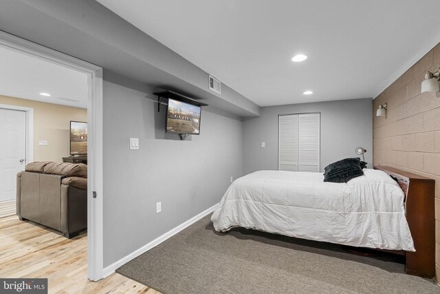 bedroom featuring hardwood / wood-style floors and a closet