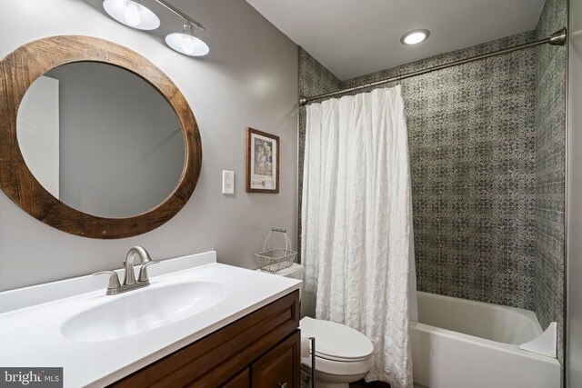 full bathroom featuring vanity, toilet, and shower / tub combo