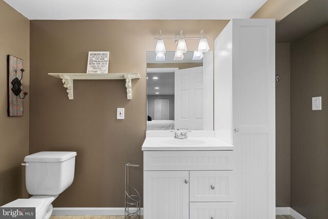 bathroom featuring vanity and toilet