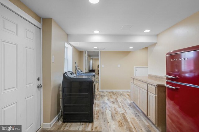 kitchen with separate washer and dryer, refrigerator, light hardwood / wood-style floors, and light brown cabinets