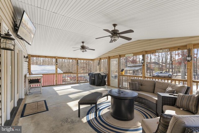 sunroom featuring vaulted ceiling and ceiling fan