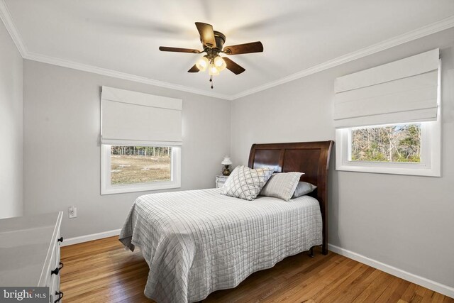 bedroom with ornamental molding, ceiling fan, and light wood-type flooring