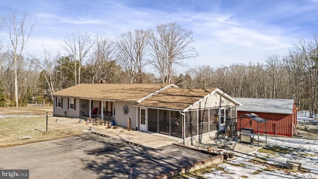 view of front facade with a patio area and a sunroom