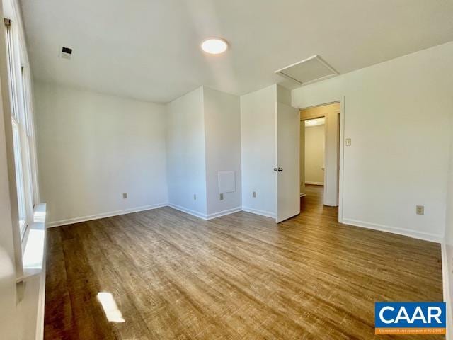 empty room with baseboards and wood finished floors