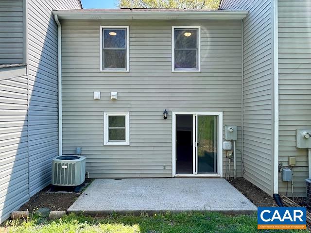 rear view of property featuring a patio and central AC