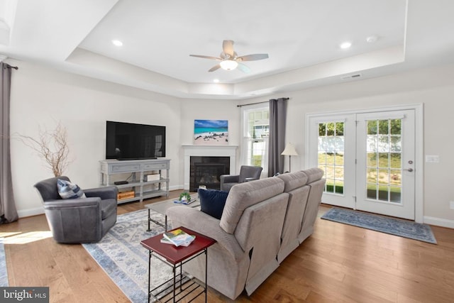 6104 New Berne Rd, Fredericksburg, VA 22407 - living room featuring a raised ceiling, wood finished floors, a ceiling fan, a glass covered fireplace, and baseboards