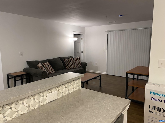 living area featuring dark wood finished floors and baseboards