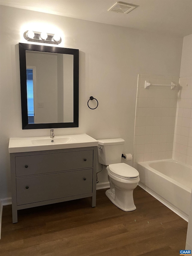 full bathroom featuring toilet, visible vents, shower / tub combination, vanity, and wood finished floors