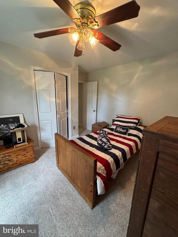 7880 Sir Topas Dr, Warrenton, VA 20186 - carpeted bedroom with a ceiling fan and a closet