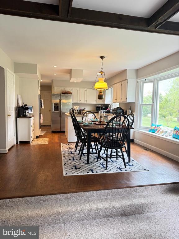 7880 Sir Topas Dr, Warrenton, VA 20186 - dining area with wood finished floors, beamed ceiling, and baseboards
