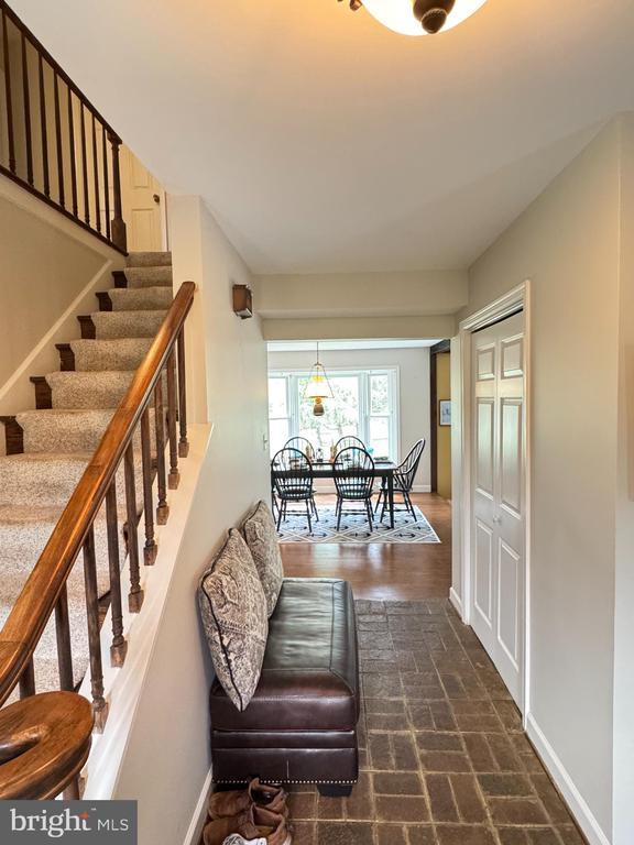7880 Sir Topas Dr, Warrenton, VA 20186 - stairs with brick patterned flooring and baseboards