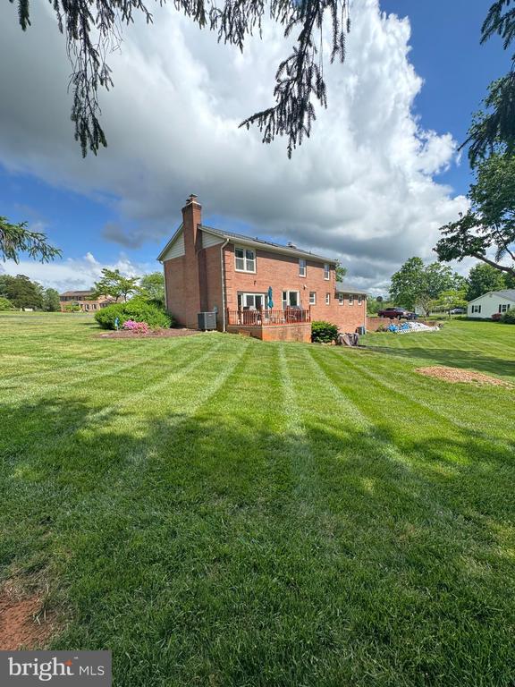 7880 Sir Topas Dr, Warrenton, VA 20186 - rear view of property with a chimney, central AC, brick siding, and a yard