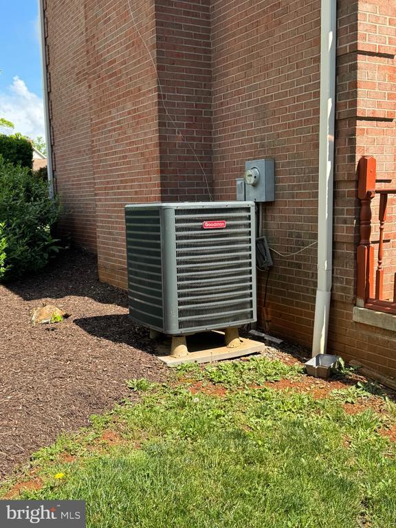 7880 Sir Topas Dr, Warrenton, VA 20186 - exterior view of central AC unit, brick siding, and electric meter