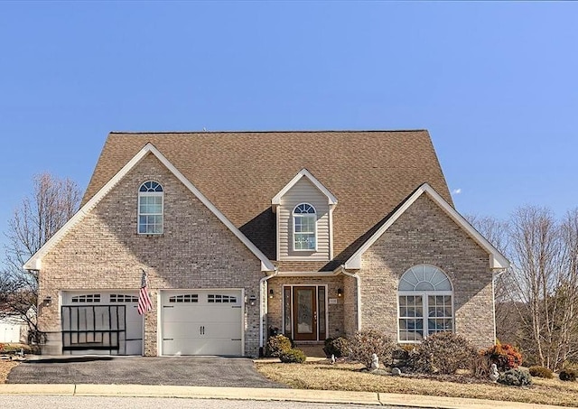 102 Shawn Cir, Staunton, VA 24401 - view of front of home with roof with shingles, brick siding, aphalt driveway, and a garage