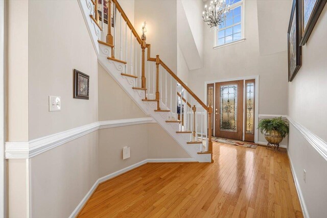 102 Shawn Cir, Staunton, VA 24401 - foyer entrance with hardwood / wood-style flooring, baseboards, stairway, a high ceiling, and a notable chandelier