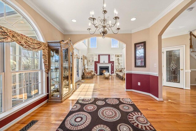 102 Shawn Cir, Staunton, VA 24401 - foyer entrance with a notable chandelier, baseboards, crown molding, wood finished floors, and arched walkways