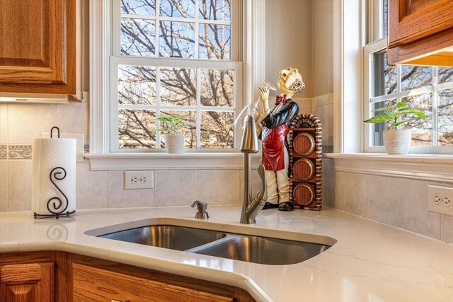 102 Shawn Cir, Staunton, VA 24401 - kitchen with a sink, brown cabinetry, a wealth of natural light, and tasteful backsplash